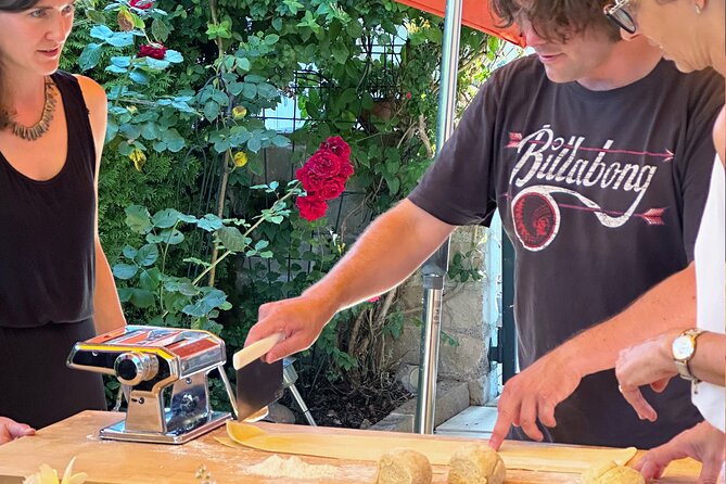Homemade Italian Lasagna Experience with a Local Family - Layering lasagna with ragù and béchamel