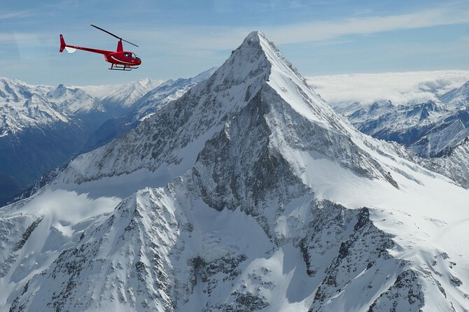 Private Swiss Alps helicopter tour over snow covered mountain peaks and glaciers - The Eiger north face and Grindelwald below